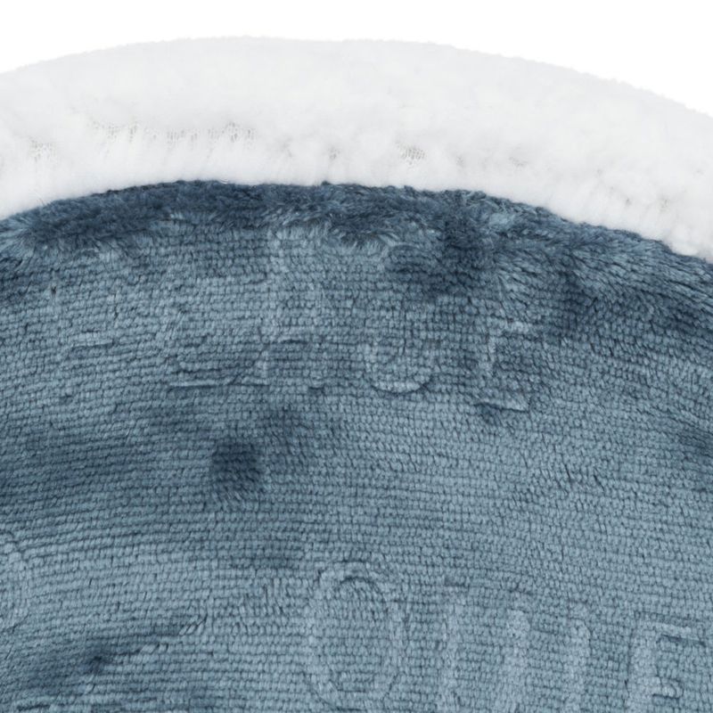 Close-up of a soft blue fabric material with a white edge. Structure and texture of the material are visible.