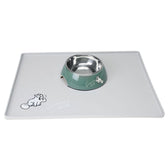 Stainless steel food bowl with green holder and grey mat, both printed with Simon's Cat design.