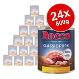 Rocco Classic Pork with beef & chicken, 24 x 800g tins. Label shows 100% fresh ingredients & grain-free recipe. Large can in front, stacked cans behind. Red badge: 24x 800g.