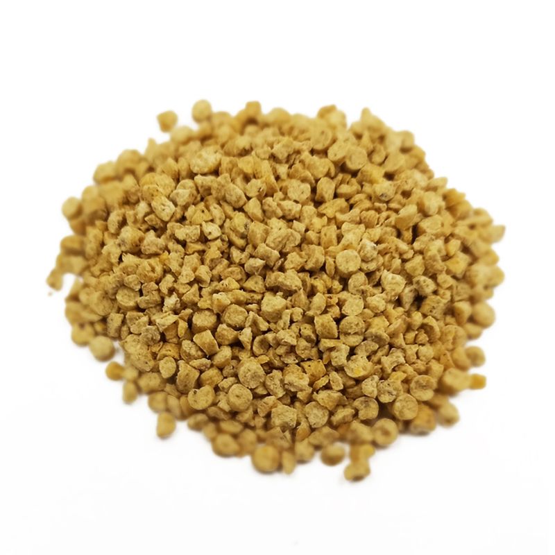 Close-up of yellowish-brown granules, possibly pet food or litter.