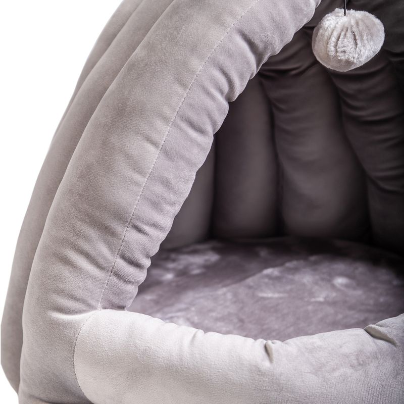 Grey, padded pet bed with soft inner lining and hanging plush ball as toy.