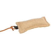 Toy made of braided natural material with orange cord and black handle.