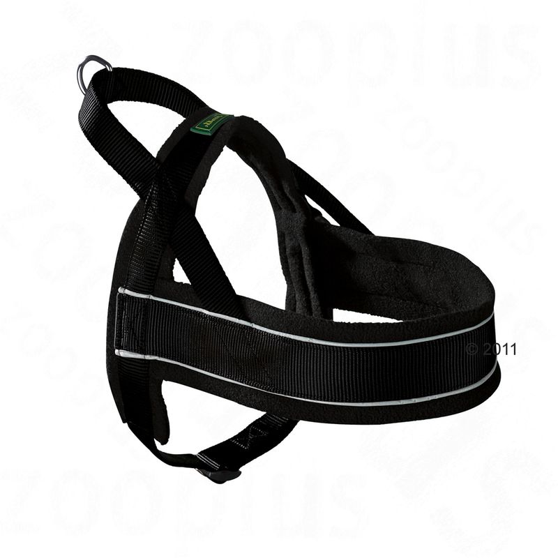 Black fabric dog harness with reflective strip, metal ring for lead attachment, and green label on strap. No visible brand or size information.