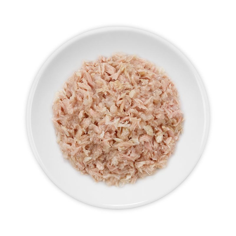 Close-up of minced pink meat in a white bowl. Product contents shown.