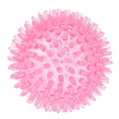 Pink studded ball made of flexible plastic, suitable for play and massage purposes.