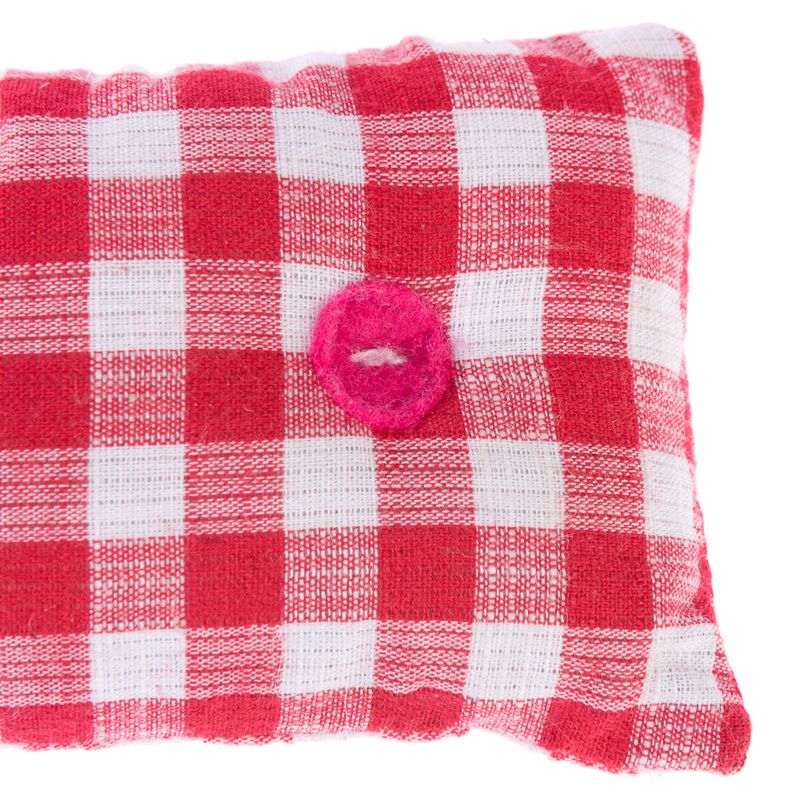 Red and white chequered cushion with a pink felt ring in the centre. Visible fabric texture.