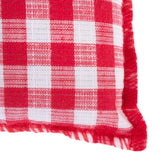 Red and white cushion with checked pattern and fringes on the edges.