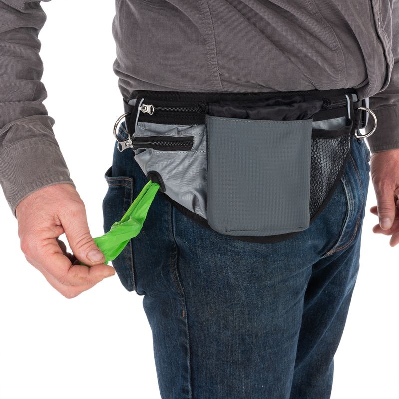 Belt bag with multiple compartments, includes dispenser for green dog waste bags. Suitable for walks or outdoor activities.