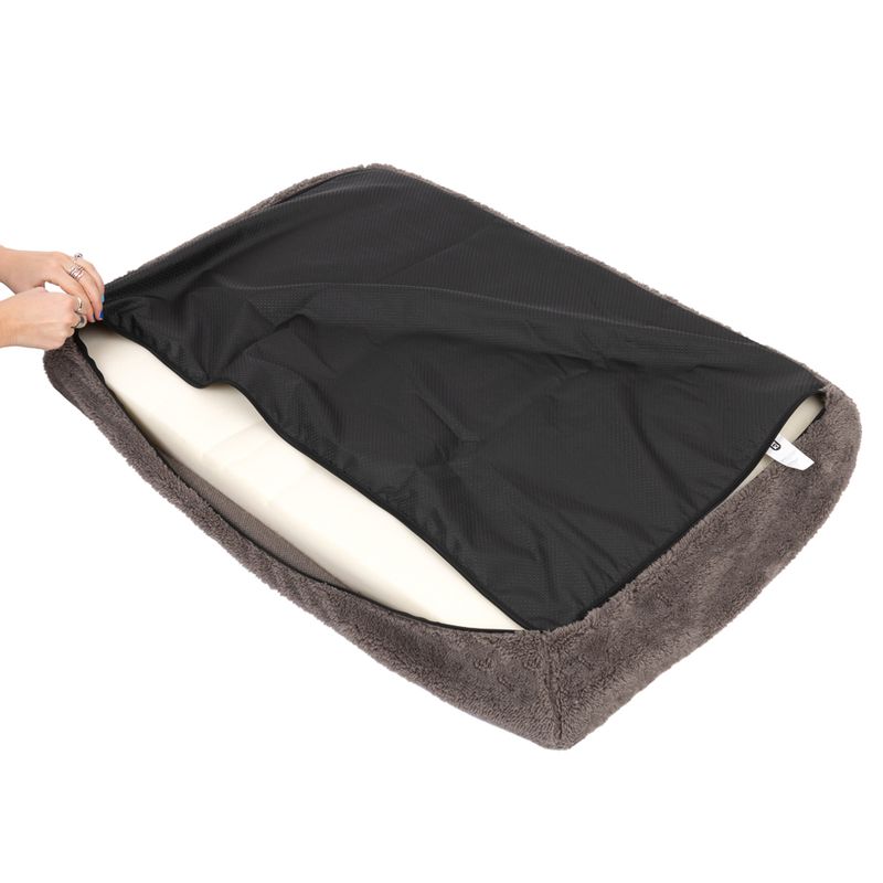 Removable black cover of a grey pet mat is shown, with visible inner padding.