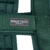 Nomad Tales München. Close-up of green fabric material with brand label.