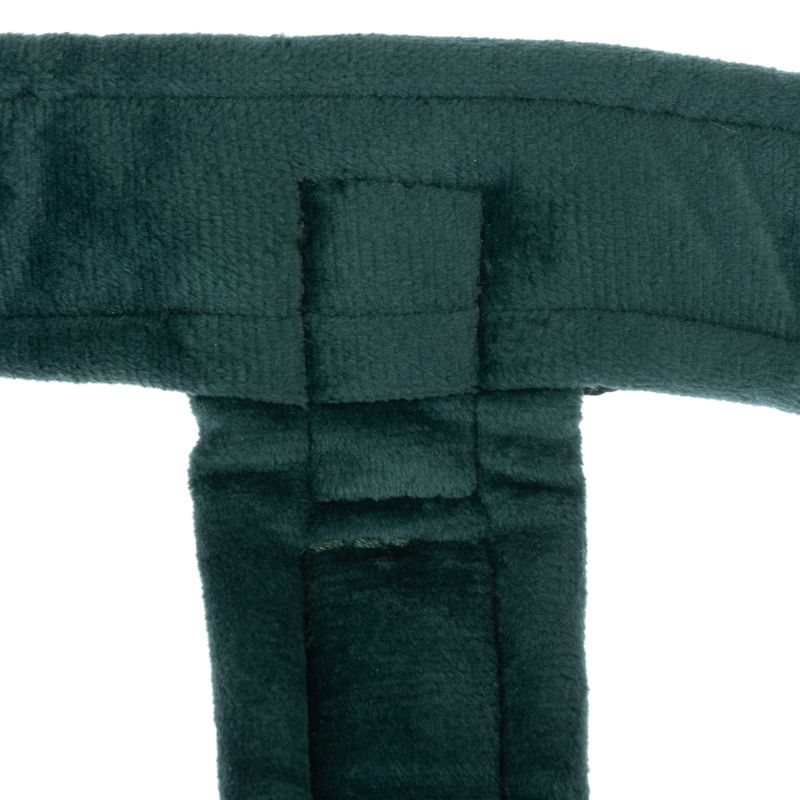 Close-up of dark green, padded fabric material with stitching. Detail view of a product part.