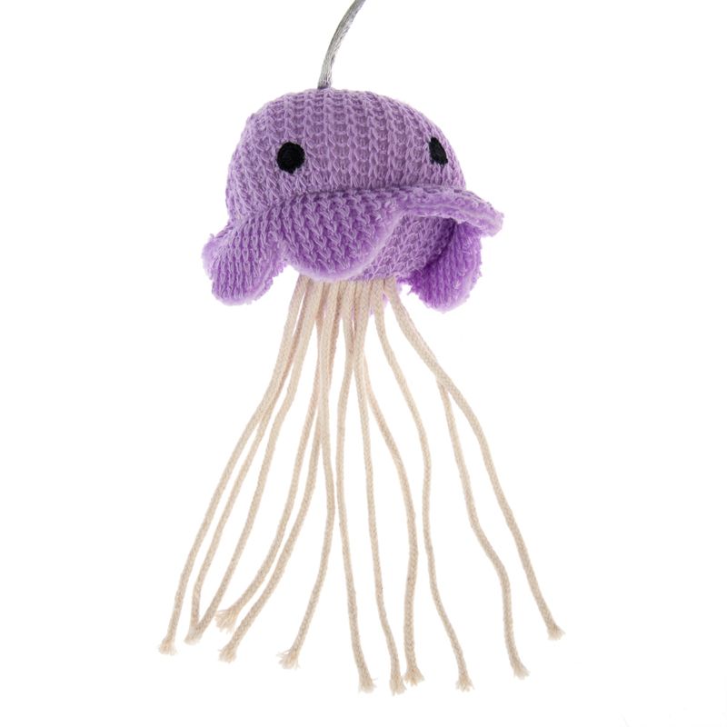 Purple crocheted toy in the shape of a jellyfish with long white threads as tentacles.