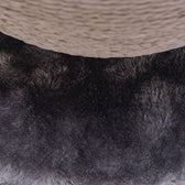 Close-up of a scratching post part with black plush and beige sisal rope.