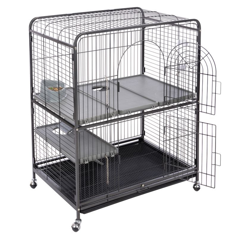Metal cage with two levels, removable plastic floors, food and water bowls, and wheels for easy movement. Side doors and mesh walls visible.