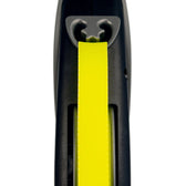 Close-up of a yellow dog lead in a black casing, showing the attachment and guidance of the lead.