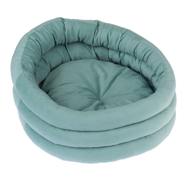 Round, padded pet bed in mint green with soft fabric and raised edge.