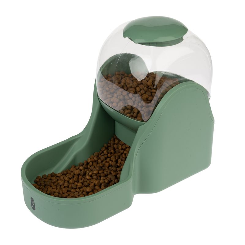 Green feeder with transparent container, filled with brown dry food pieces. Food slides into a bowl at the bottom.