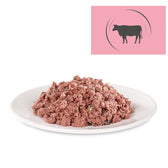 Portion of wet food on a white plate, cow symbol on a pink background indicates beef as an ingredient.