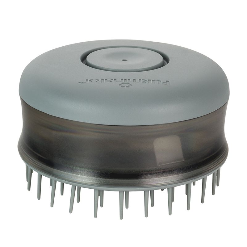 Round grooming brush with soft bristles and a push button on top, designed for detangling and massaging fur during pet care routines.