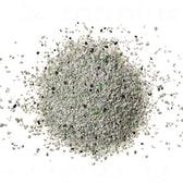 Close-up of cat litter with grey, black and green granules.