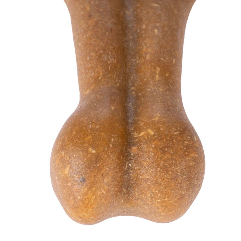 Close-up of a brown, bone-shaped chew made from compressed material.