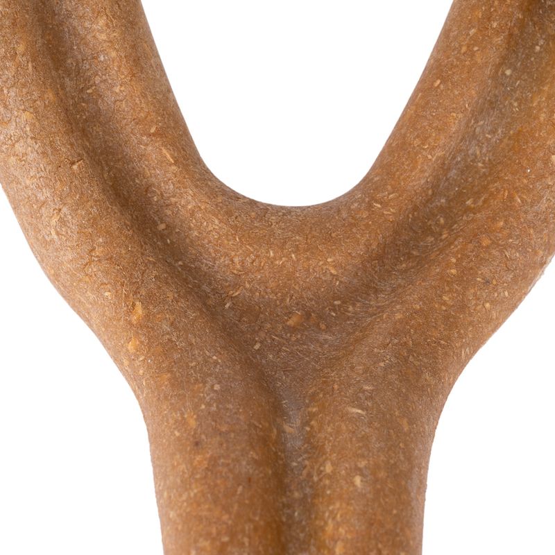 Close-up of a brown Y-shaped chew toy made from compressed material.