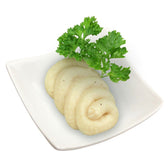 White paste arranged in a spiral on a plate, garnished with fresh parsley.