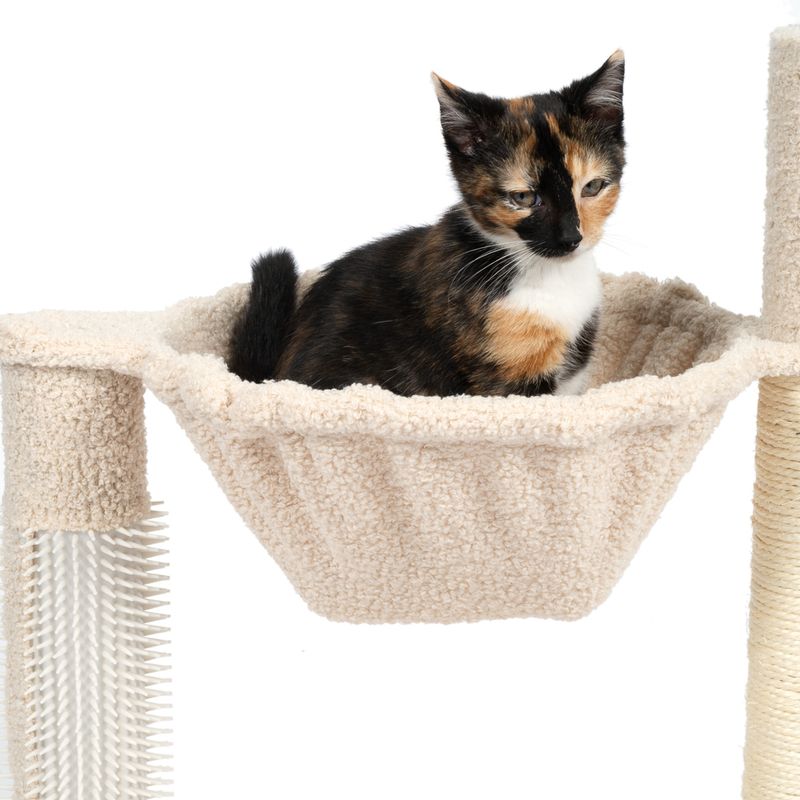 Cat sitting in a beige hammock platform attached to a scratching post, demonstrating use of the product as a resting area.