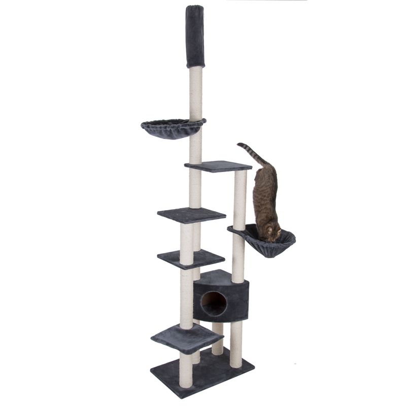 Tall multi-level cat tree with platforms, two hammock beds, a scratching post and a small cubby hole, shown with a cat using one of the hammocks.