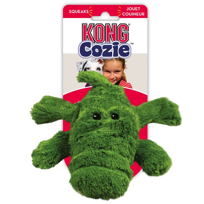 KONG Cozie green plush toy for dogs, squeaks. Packaging with red background and product name visible.
