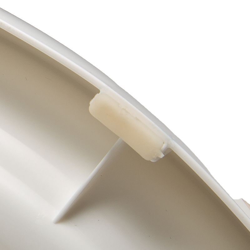 Close-up of a white plastic part with a small holder or clip on the edge.