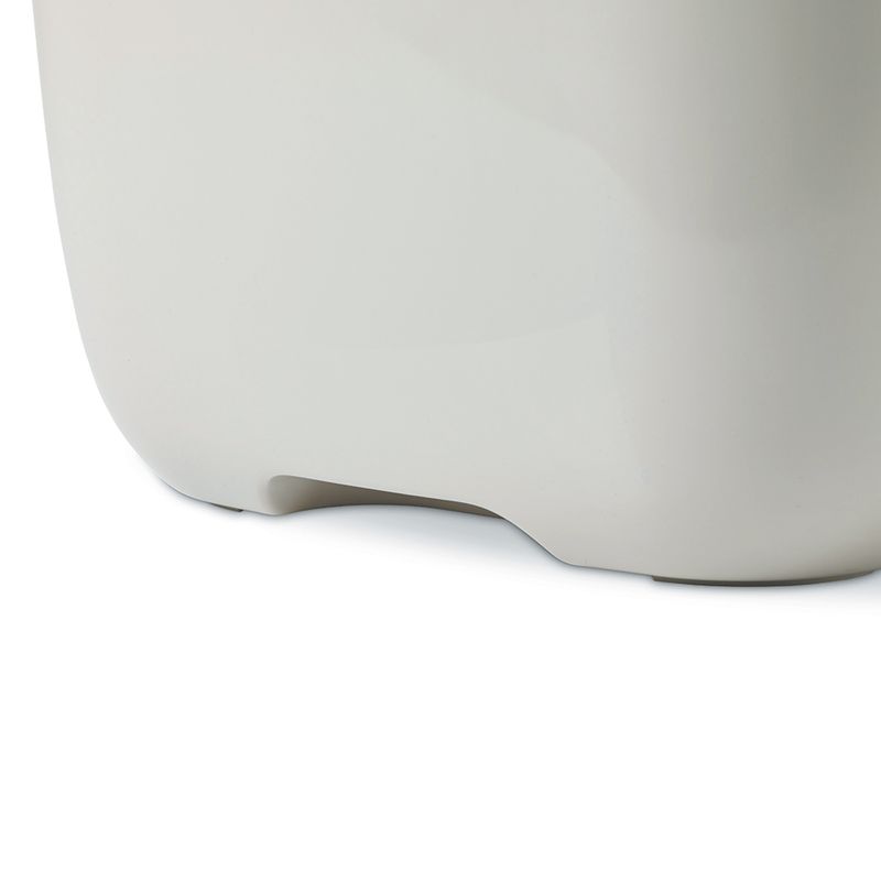 Close-up of a white plastic container with rounded corners and a recess at the bottom.