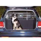 Dog sitting in the boot of a car with installed safety grille partition for secure transport.