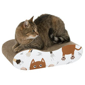 Brown cat lying on a cardboard scratch board with cat motifs. Product for activity and claw care for cats.