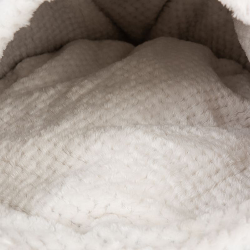 Close-up of soft, white plush material with textured surface, suitable for pet beds or blankets.