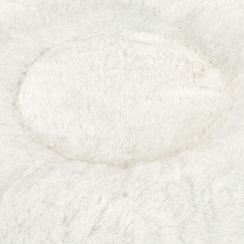 Close-up of a white, fluffy material, possibly for a pet bed or blanket.