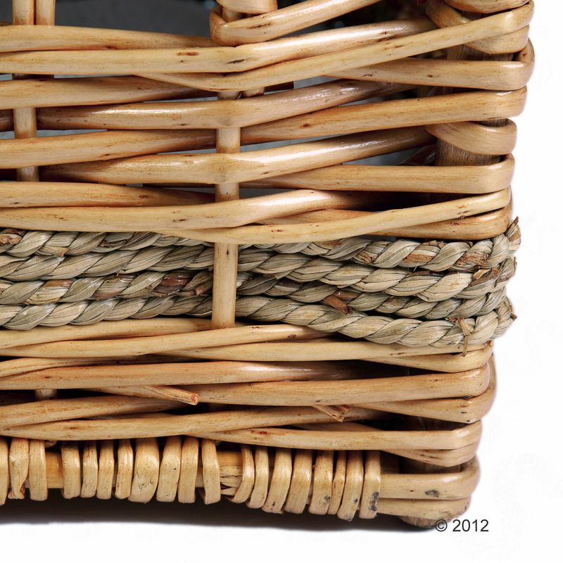 Close-up of a basket made from woven natural material, light brown wood and grey bast weave.