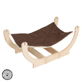 Wooden hammock with brown fabric cover, suitable for small pets. Round wooden frame and stable base visible.
