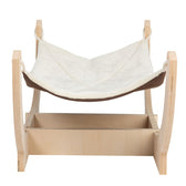 Wooden frame with white fabric hammock, suitable for small animals. Base with storage shelf.