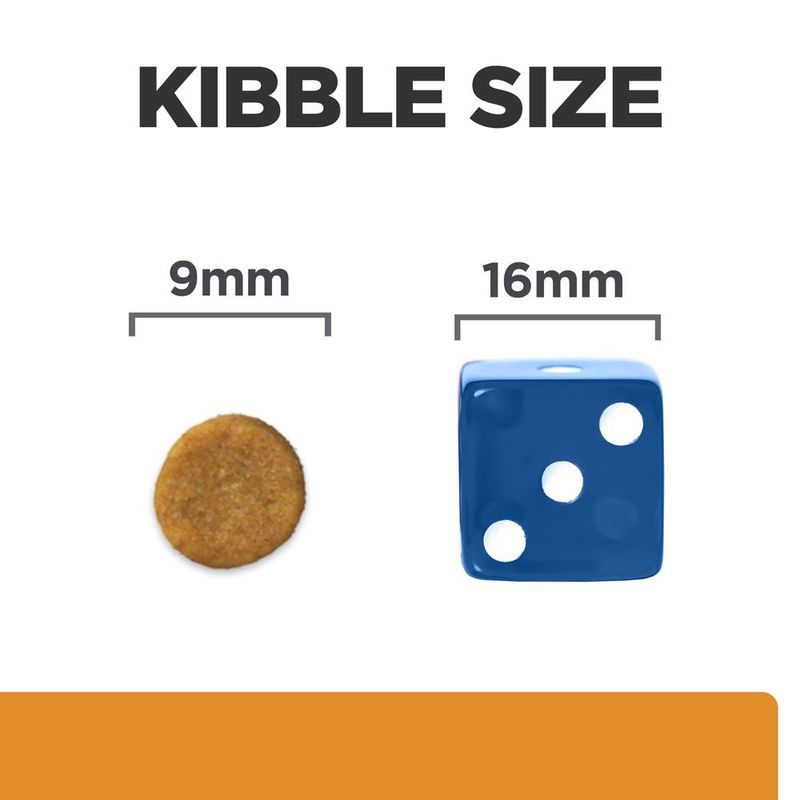 Kibble size comparison showing a 9mm round kibble next to a 16mm blue dice for scale.