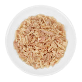 Close-up of shredded meat in a white bowl, likely wet food for pets.