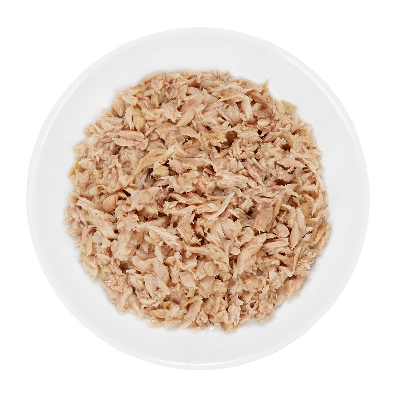 Close-up of shredded, cooked chicken meat in a white bowl. Shows the texture and colour of the product.
