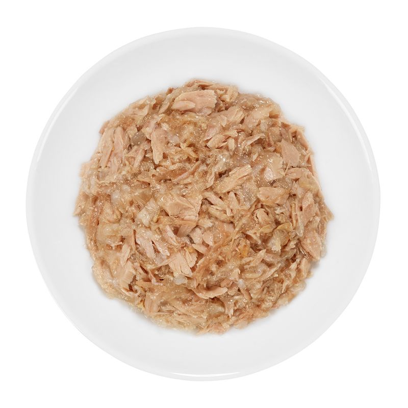Close-up of shredded meat in a white bowl, showing the consistency and texture of the wet food.
