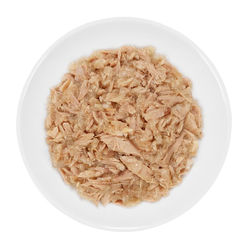 Close-up of shredded tuna in a white bowl, suitable as pet food.