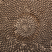 Close-up of a spiral corrugated cardboard structure, suitable for scratching surfaces or cardboard toys.