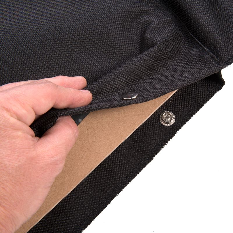 Close-up of a black, removable fabric cover with press stud fastening and underlying wooden board.