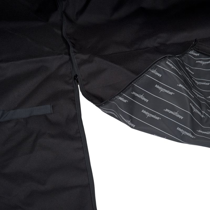 Close-up of a black fabric product with an open zip, showing the inner lining and branded text pattern. Highlights material and construction details.