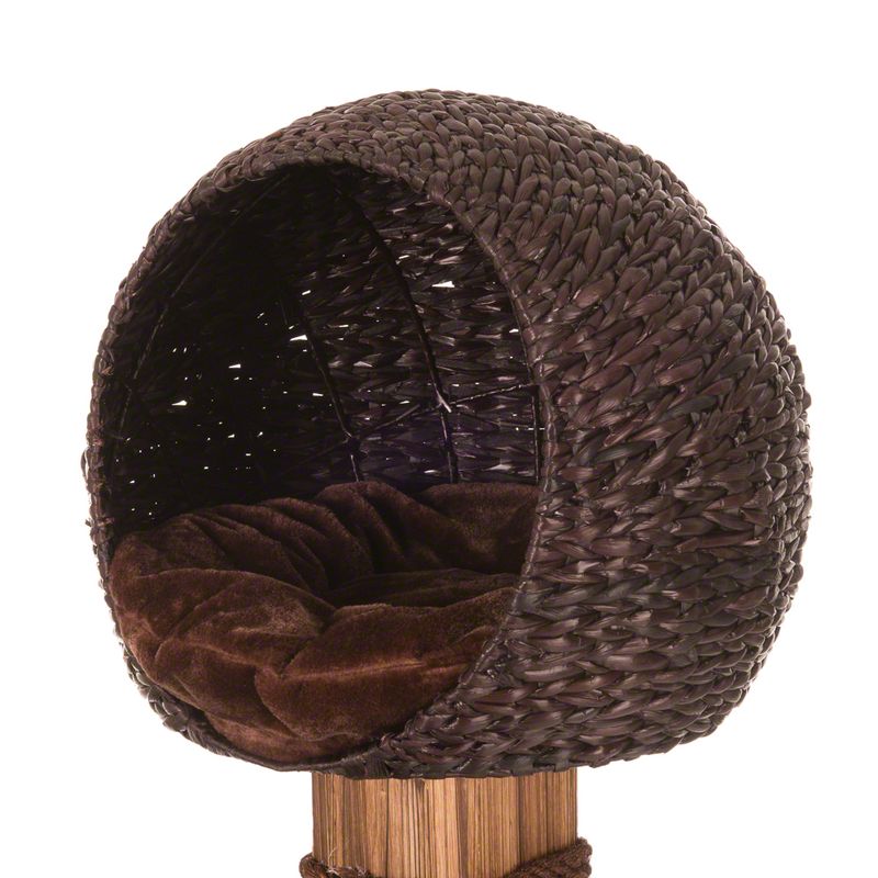 Round cat bed made of brown woven material with a soft, dark brown cushion. Bed mounted on a wooden stand.