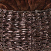 Close-up of a brown basket made of woven natural material with soft brown inner lining.