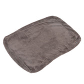 Grey rectangular plush mat with soft surface and rounded corners. Small brand label visible on the side.